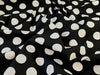 Black fabric with white polka dot pattern