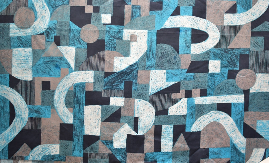 A piece of cotton twill fabric with a geometric graphic print in multiple colors.