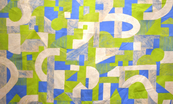 a close up of a green and blue geometric fabric
