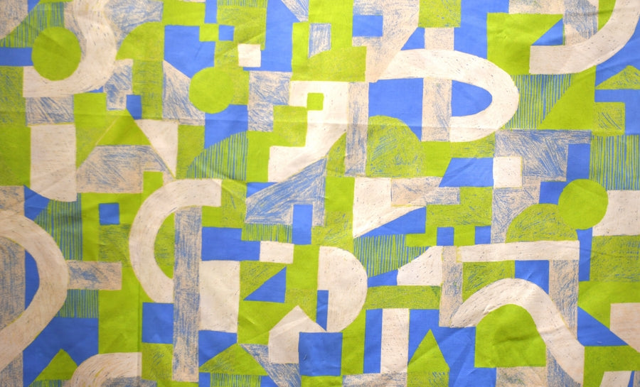 a close up of a green and blue geometric fabric