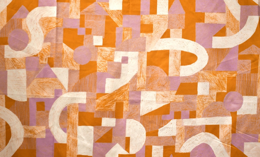 a close up of lilac and orange geometric fabric