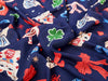 Navy blue fabric with colorful graphics including dogs, leaves, and abstract shapes.