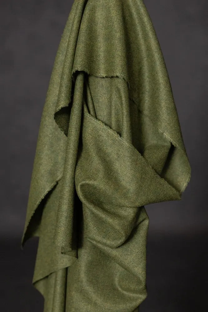 Green fabric draped over a dark background
