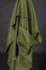 Green fabric draped over a dark background