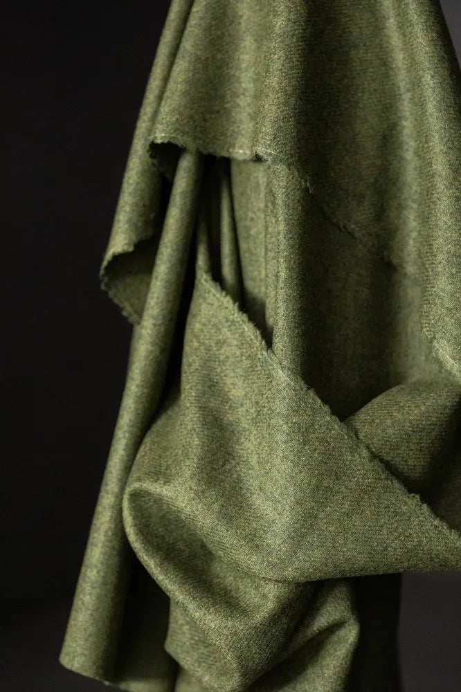 Close-up of a green fabric texture on a dark background