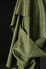 Close-up of a green fabric texture on a dark background