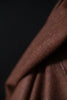 Close-up of brown fabric texture on a dark background