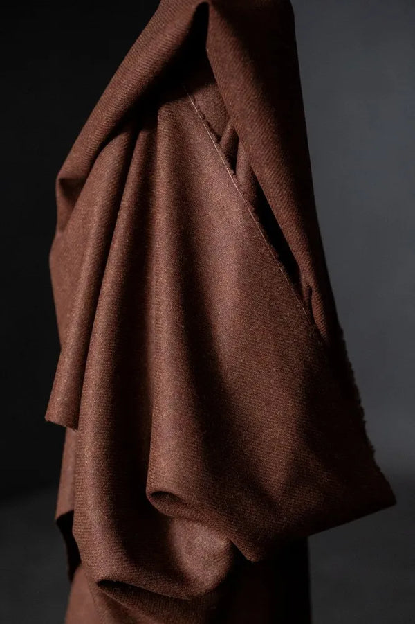 Brown fabric draped over a dark background