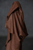Brown fabric draped over a dark background