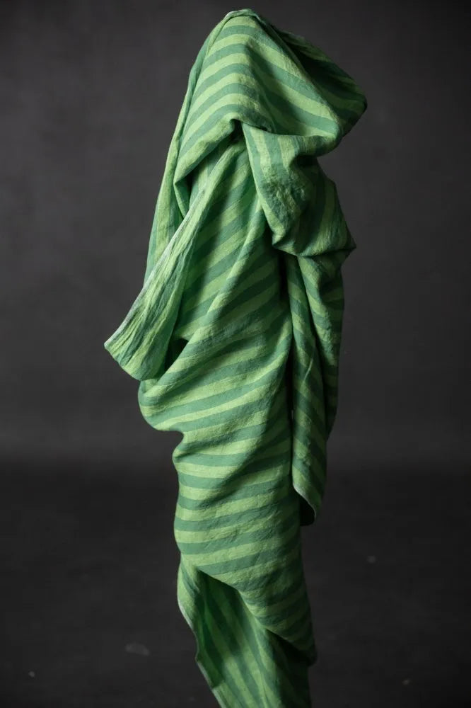 a bolt of green stripe linen fabric
