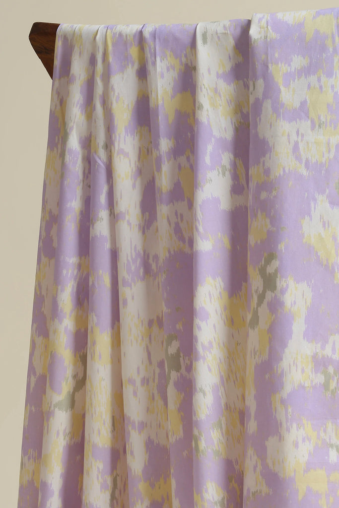 Floral patterned fabric draped over a wooden rod against a beige background