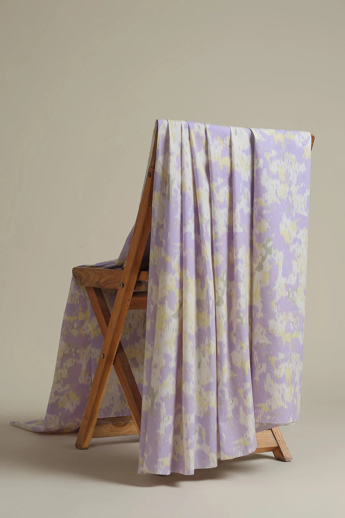 Floral-patterned blanket draped over a wooden folding chair against a beige background