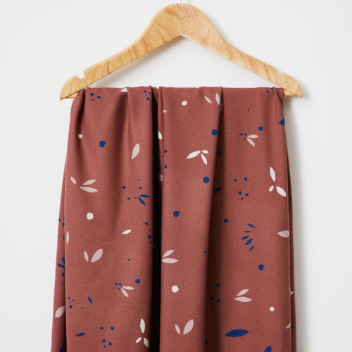 a swatch of red fabric draped on  a hanger