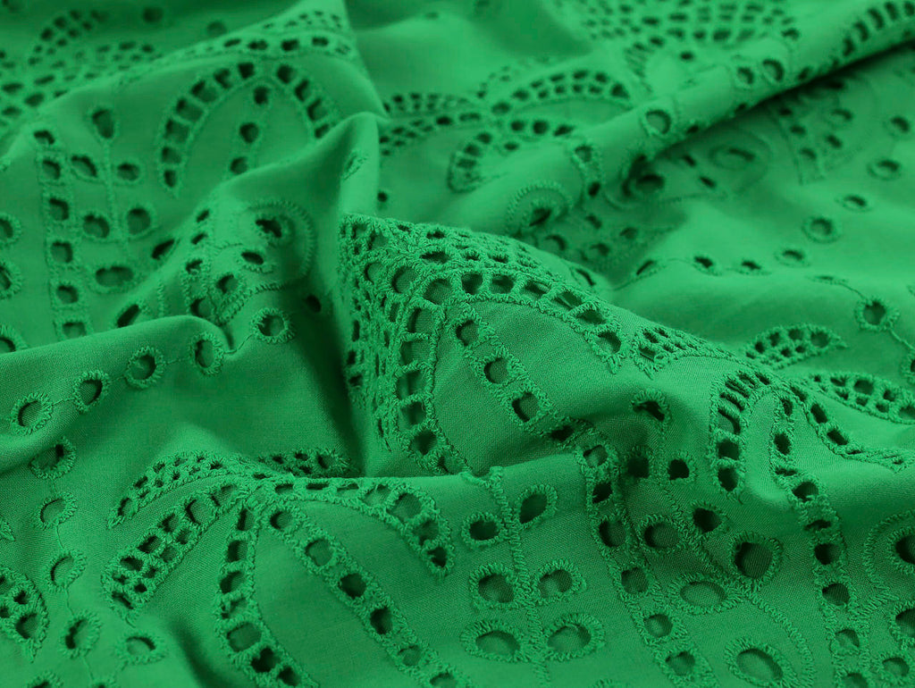 Green lace fabric with intricate patterns