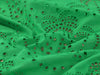 Close-up of green lace fabric with intricate patterns