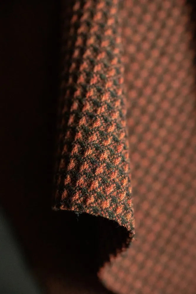 Close-up of textured brown fabric with a subtle pattern