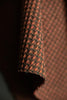 Close-up of textured brown fabric with a subtle pattern