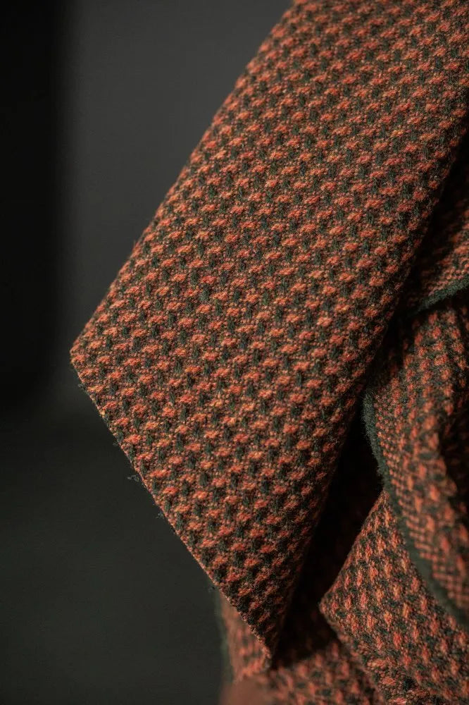 Close-up of a textured brown and black fabric with a subtle pattern.