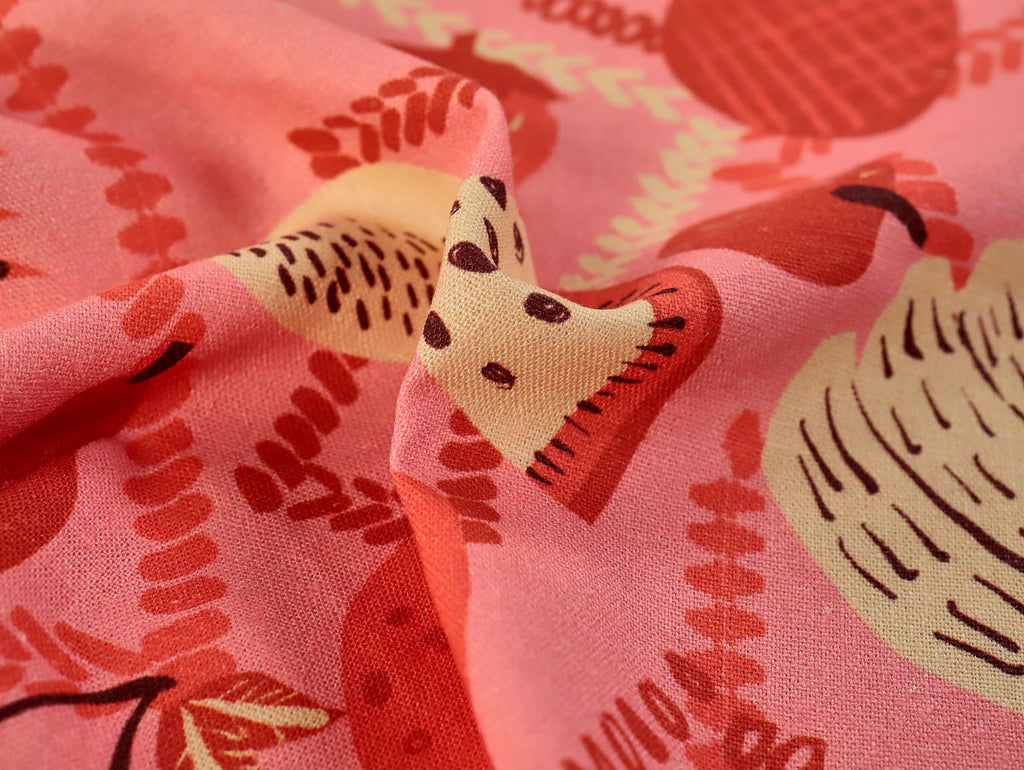 Close-up of a pink fabric with red and yellow pattern