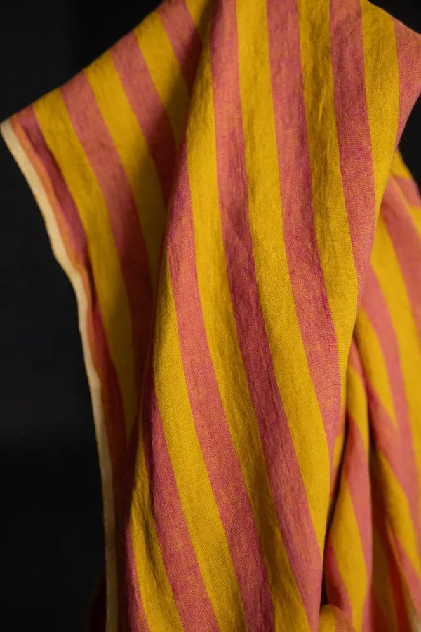 Close-up of a yellow and red striped fabric against a black background
