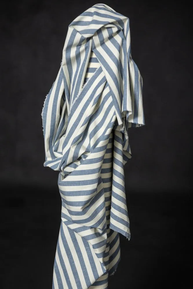 Striped fabric with blue and white pattern on a black background