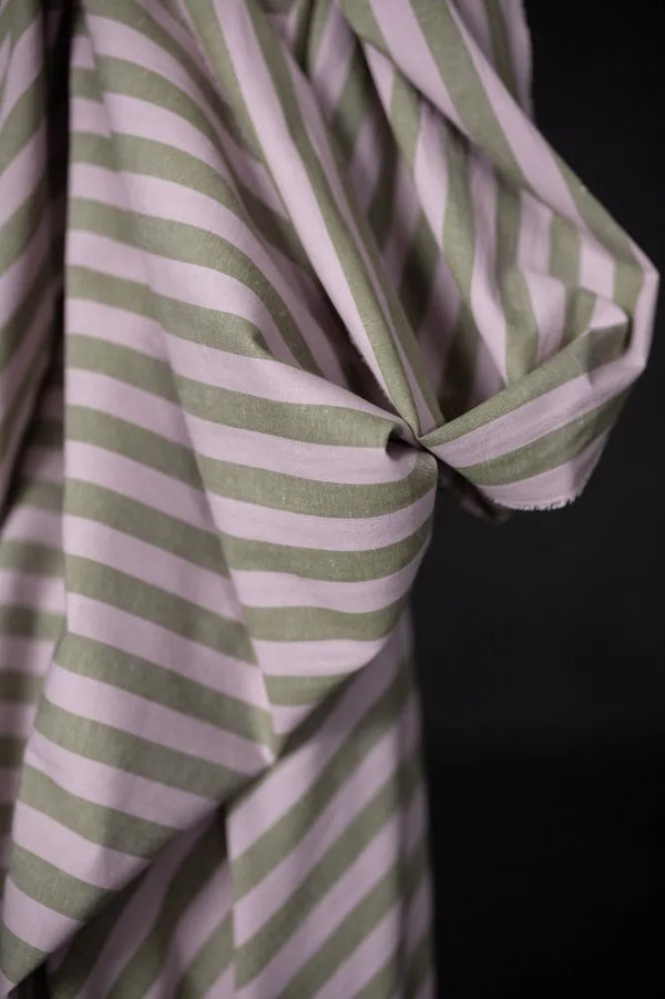 Close-up of a green and white striped fabric against a black background