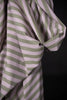Close-up of a green and white striped fabric against a black background