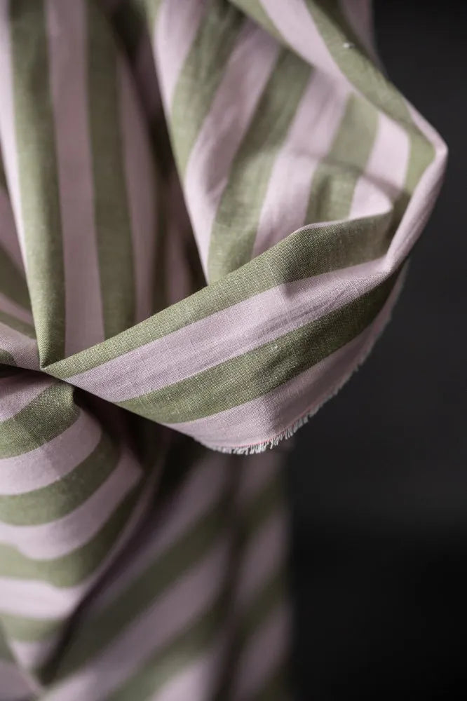 Close-up of a green and white striped fabric against a dark background