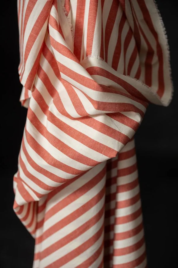 Red and white striped fabric on a black background