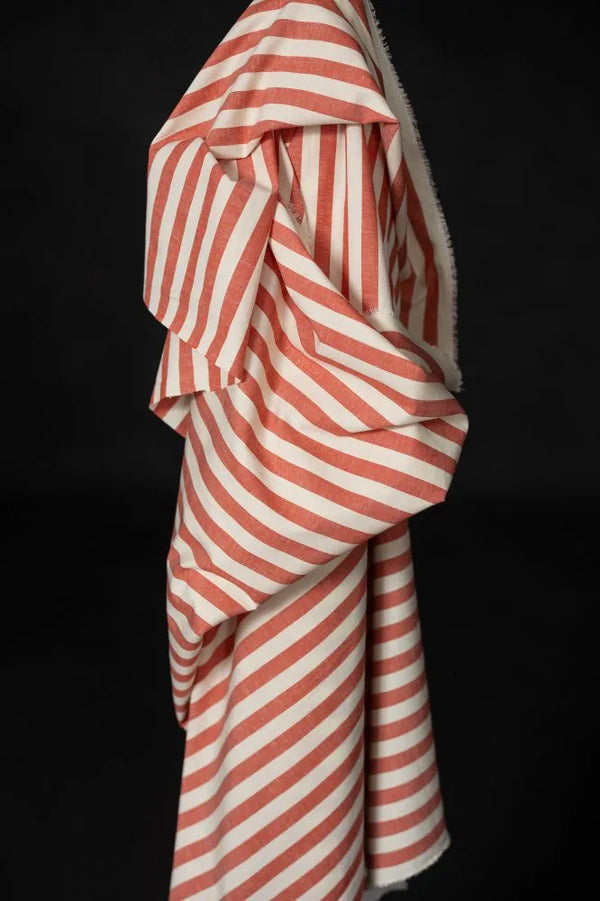 Red and white striped fabric draped over a black background