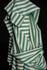 Green and white striped fabric on a black background