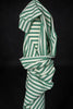 Green and white striped fabric on a black background