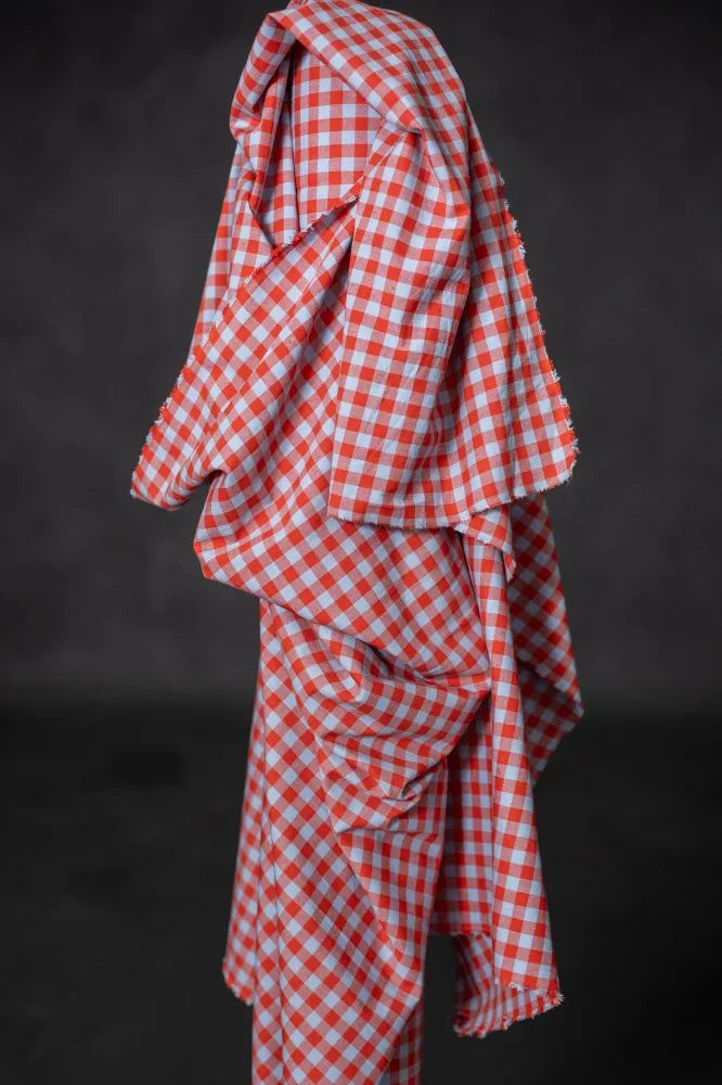 Red and white checkered fabric draped over a black background