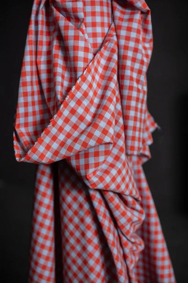Red and white checkered fabric on a dark background