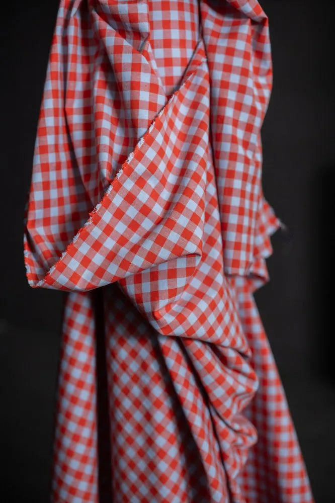 Red and white checkered fabric on a dark background