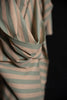Close-up of a striped fabric with green and brown colors on a black background