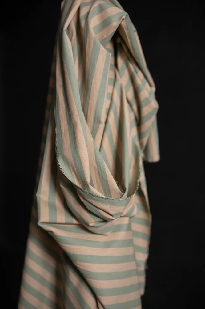Striped fabric with green and beige pattern on a black background