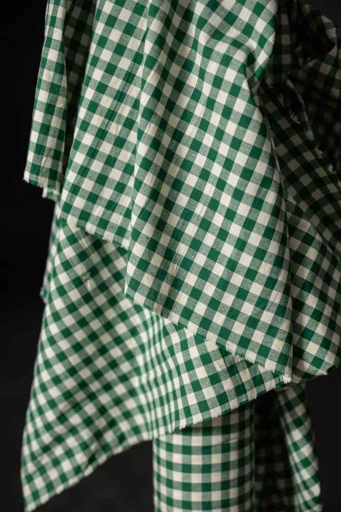 Green and white checkered fabric on a black background