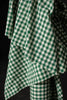 Green and white checkered fabric on a black background