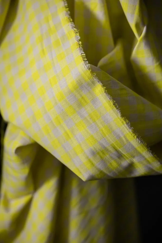 Close-up of yellow fabric with white polka dots