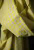 Close-up of yellow fabric with white polka dots
