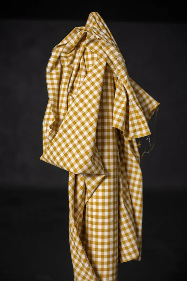Yellow checkered fabric draped over a black background