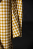 Close-up of a yellow and white checkered fabric against a black background
