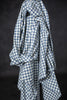Blue and white checkered fabric draped over a black background
