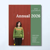 Shetland Wool Week Annual 2026 magazine cover, Volume Twelve, featuring a woman in a green sweater against a red corrugated metal background on the left, and a muted green panel on the right with white text.