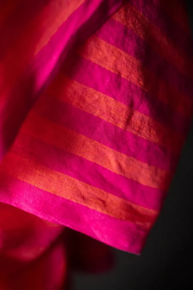 A close-up of orange and pink striped linen fabric