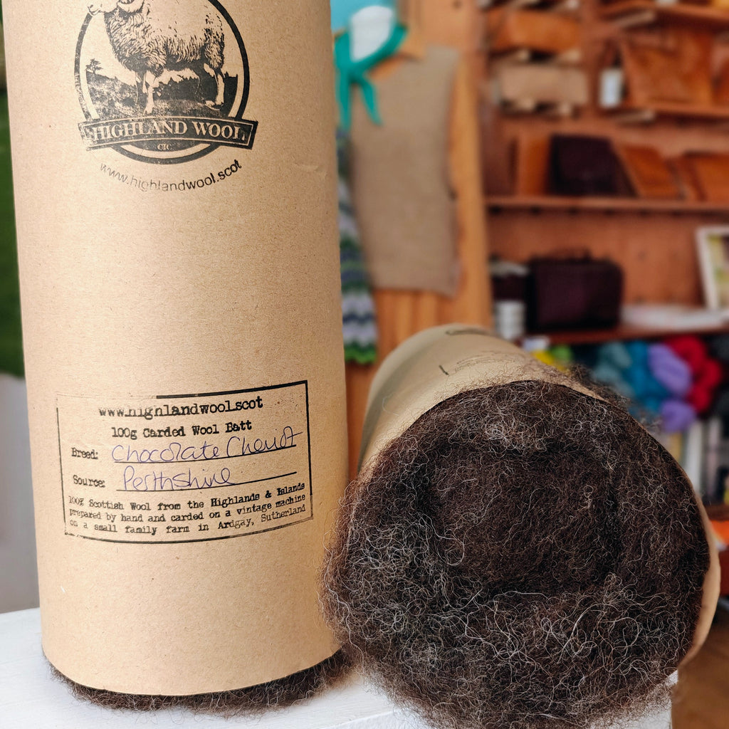 Carded wool bale with cardboard tube packaging in a store setting