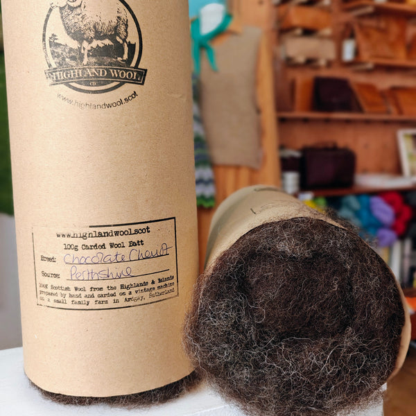 Carded wool bale with cardboard tube packaging in a store setting