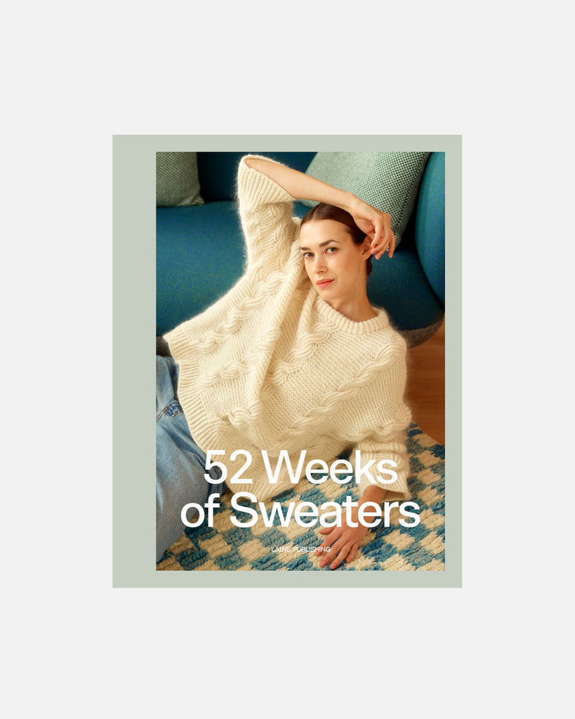 Book cover titled '52 Weeks of Sweaters' featuring a person wearing a white sweater.