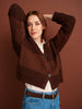 Woman wearing a brown knitted cardigan against a brown background